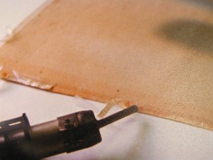 Ablösen von Selbstklebebändern, die hier auf einem Dokument starke und schwierig zu entfernende Klebstoffrückstände hinterlassen haben